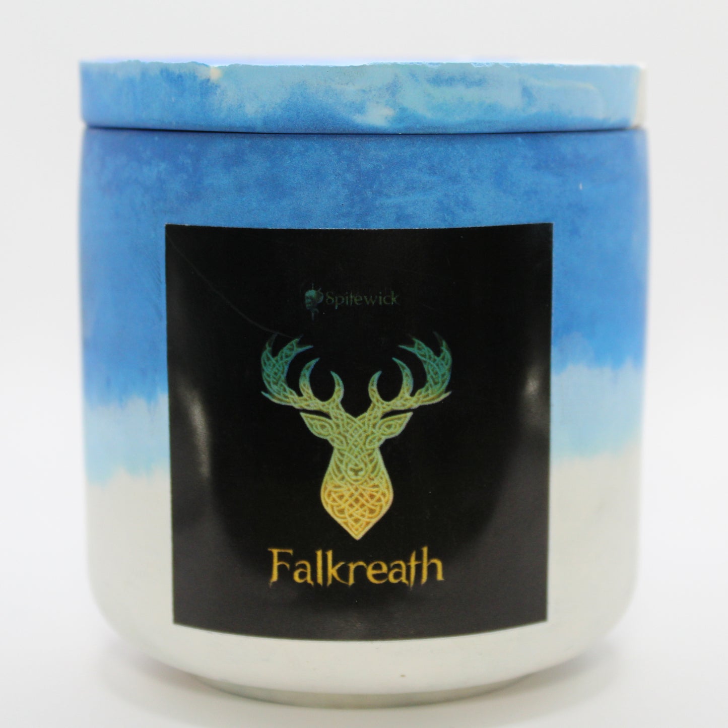 A blue and white candle holder with a sleek black label, featuring a deer intricately designed in stylized gold Celtic knotwork. Beneath the design, the name Falkreath is elegantly printed in gold, adding a bold yet sophisticated touch. Set against a clean white background, this handcrafted candle blends tradition with modern artistry, perfect for unique home decor, gifts, and personal expression.