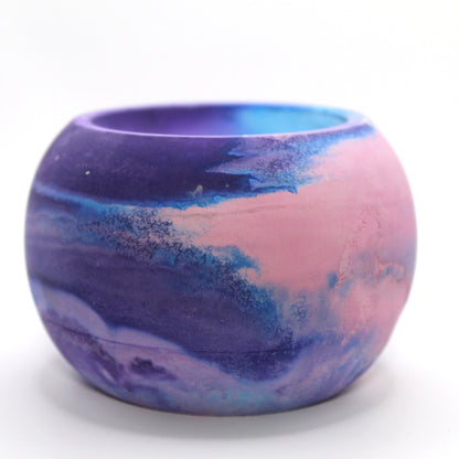 "Handcrafted Ecocrete candle holder featuring the pink, blue and purple colors of the Bisexual pride flag, elegantly blended together. Set against a clean white background, this unique design celebrates identity and personal expression. Perfect for LGBTQ+ decor, pride gifts, and home ambiance.